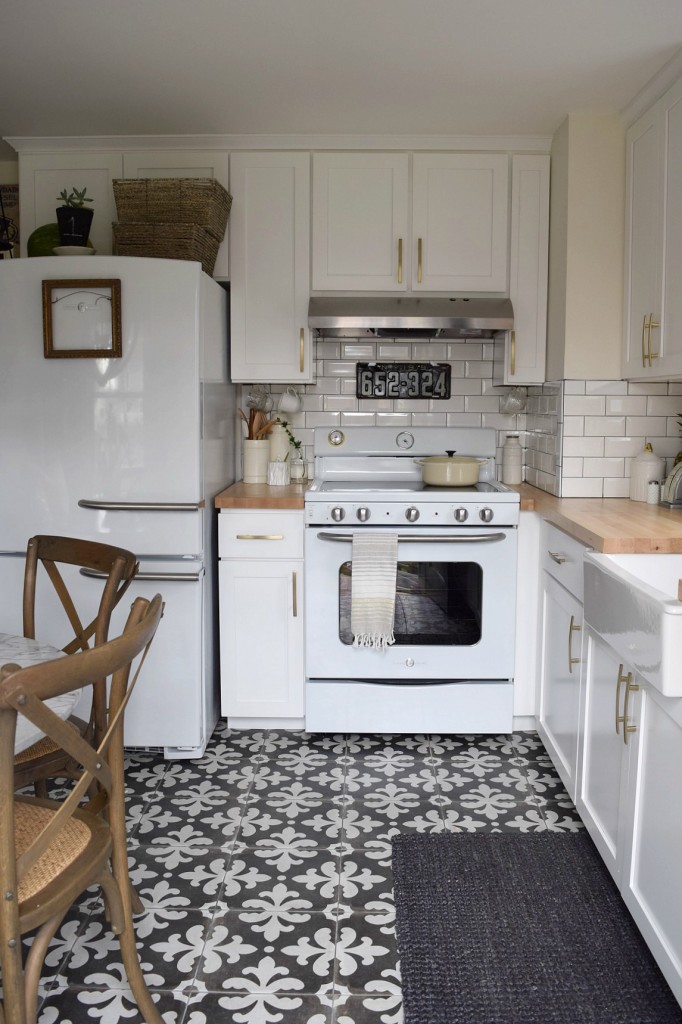 White Kitchen remodel with patterned tile and butcher block counter tops. Retro oven and fridge.