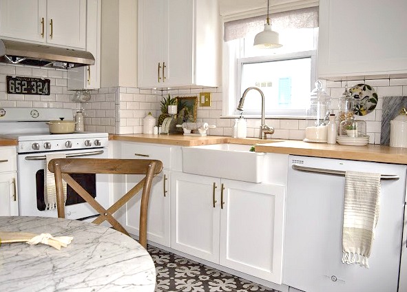 White Kitchen remodel with patterned tile and butcher block counter tops.