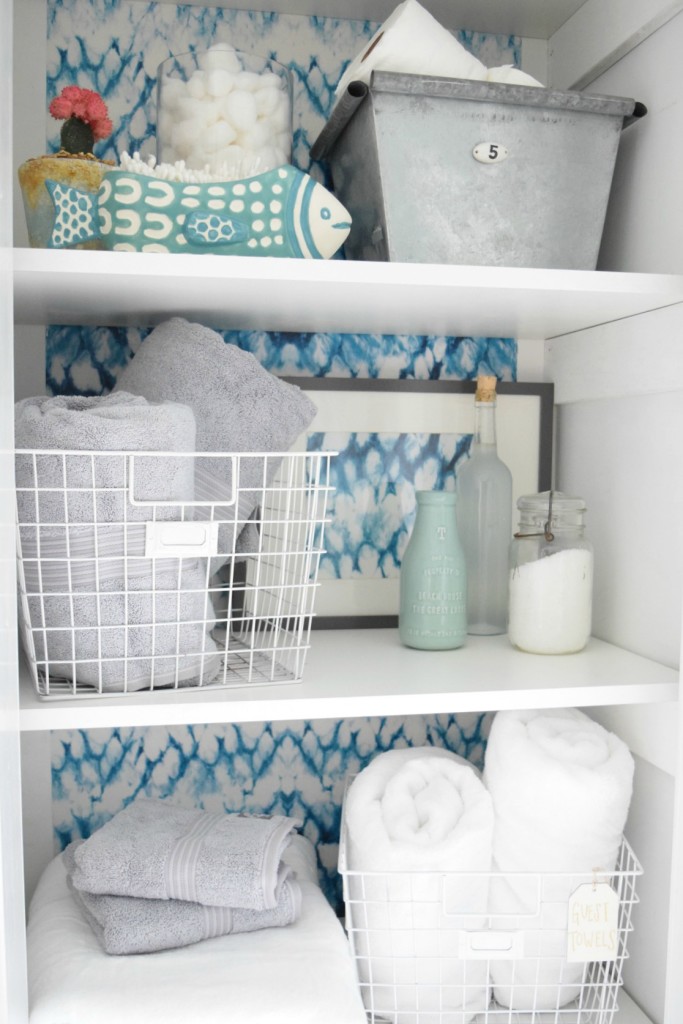 Organizing a closet in a bathroom with wallpaper