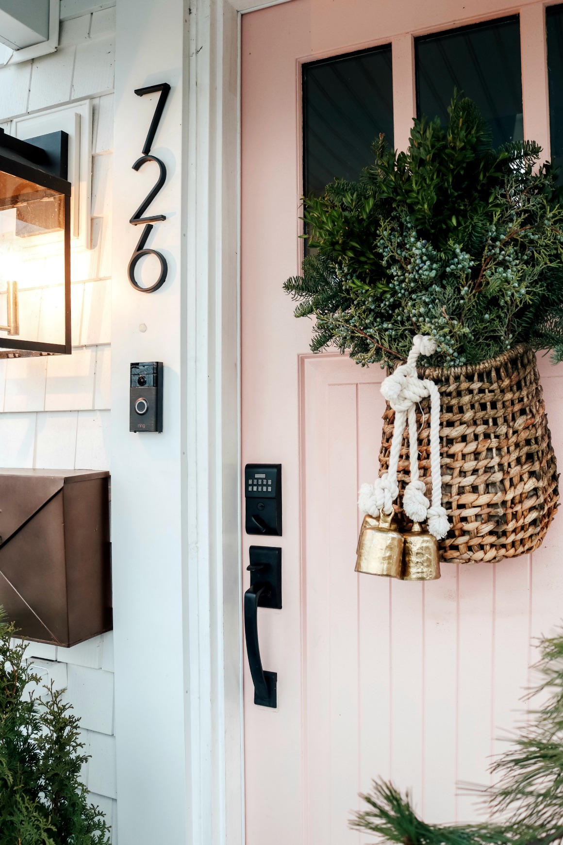 Christmas Front Porch with Fresh Greens and Pink Front Door 