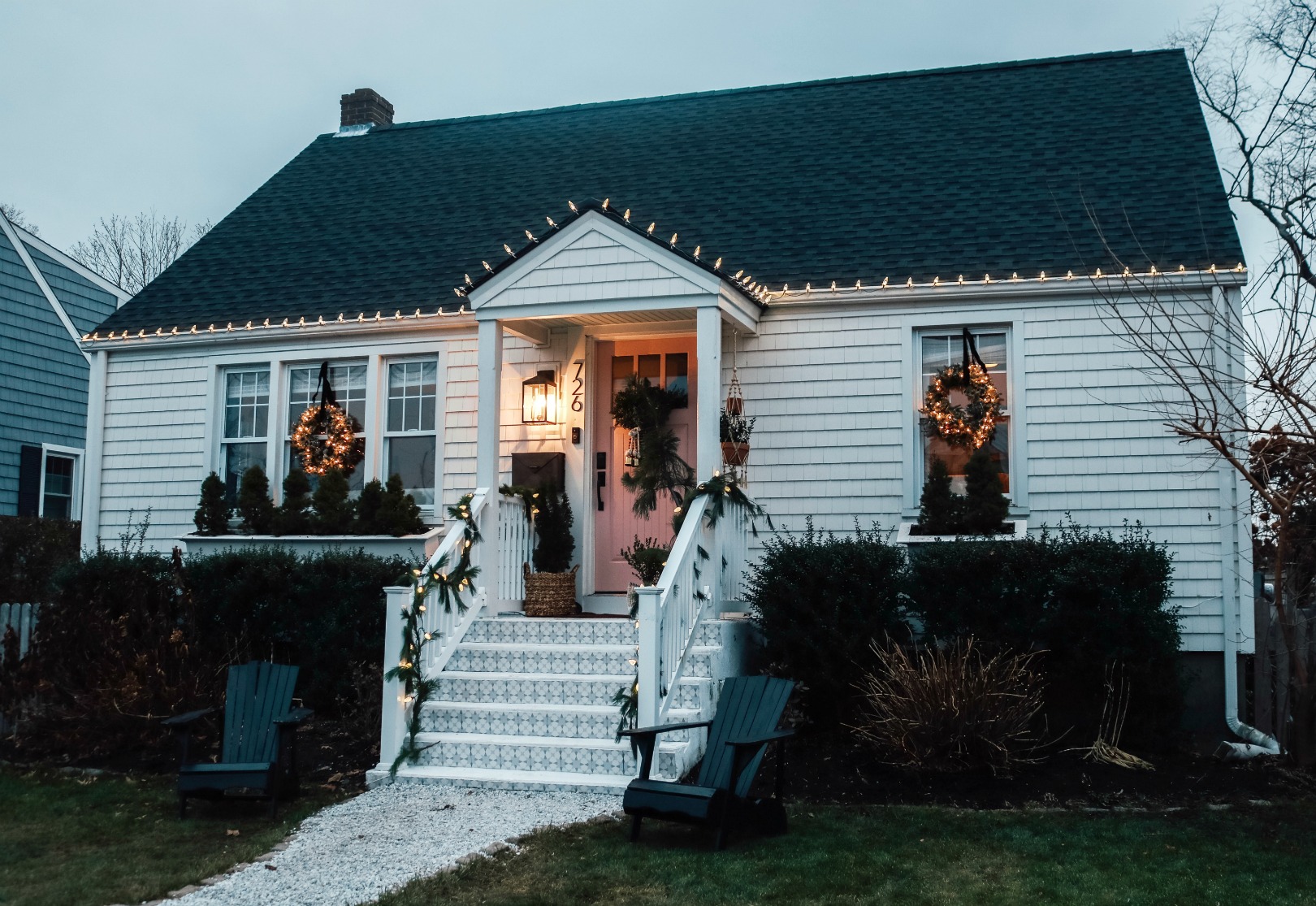 Christmas Front Porch with Fresh Greens and Pink Front Door 