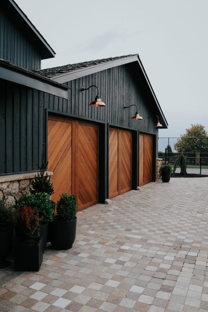 Wood Garage Doors and Copper Exterior Lights Over Doors